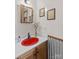 Unique bathroom vanity with a red vessel sink and framed mirror at 341 N Mulberry St, Statesville, NC 28677