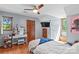 Comfortable bedroom with a ceiling fan and natural light, complemented by modern decor and wood floors at 341 N Mulberry St, Statesville, NC 28677