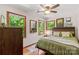 Cozy bedroom with wood floors and natural light, complemented by dark wooden furniture and vibrant green outdoor views at 341 N Mulberry St, Statesville, NC 28677
