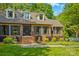 Inviting brick home featuring dormer windows, dark shutters, and professional landscaping at 341 N Mulberry St, Statesville, NC 28677