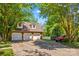 Three car garage with a large driveway and lush trees around the property at 341 N Mulberry St, Statesville, NC 28677