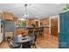 Spacious kitchen with light wood cabinetry, an island with bar seating, and stainless-steel appliances at 341 N Mulberry St, Statesville, NC 28677