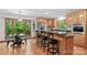 Bright eat-in kitchen with wood cabinets, granite countertops, island seating, and stainless steel appliances at 341 N Mulberry St, Statesville, NC 28677