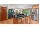 Open concept kitchen with stainless steel appliances, granite countertops, cooktop island and hardwood floors at 341 N Mulberry St, Statesville, NC 28677