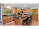 Well-lit kitchen with wood cabinets, stainless steel appliances, granite countertops, and island seating at 341 N Mulberry St, Statesville, NC 28677
