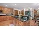 Spacious kitchen featuring wood cabinets, granite countertops, a cooktop island, and hardwood floors at 341 N Mulberry St, Statesville, NC 28677