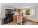 A compact kitchen featuring wood cabinets, an island with seating, and modern appliances at 341 N Mulberry St, Statesville, NC 28677