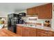Functional kitchen area with wood cabinets, stainless steel appliances, and a charming coffee station at 341 N Mulberry St, Statesville, NC 28677