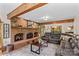 Cozy living room with a large brick fireplace, exposed beams, and a comfortable leather sofa at 341 N Mulberry St, Statesville, NC 28677