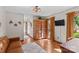 Inviting living room featuring hardwood floors, modern lighting, and a statement armoire by the window at 341 N Mulberry St, Statesville, NC 28677