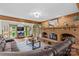 Spacious living room featuring a brick fireplace, hardwood floors, and large windows at 341 N Mulberry St, Statesville, NC 28677