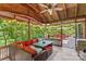 Inviting outdoor patio featuring wicker furniture, string lights, and a view of the surrounding greenery at 341 N Mulberry St, Statesville, NC 28677