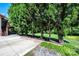 Large, grassy backyard is bordered by tall evergreen trees at 3520 4Th Street Nw Blvd, Hickory, NC 28601