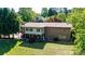 Spacious backyard features a deck, brick accents, and plenty of room for outdoor activities and entertaining at 3520 4Th Street Nw Blvd, Hickory, NC 28601