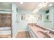 Well-lit bathroom features double sinks and a tiled shower and tub perfect for relaxation at 3520 4Th Street Nw Blvd, Hickory, NC 28601