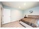 Bright and airy bedroom with a tufted headboard, lamp, and a large open door at 3520 4Th Street Nw Blvd, Hickory, NC 28601
