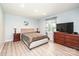 Spacious bedroom with a tufted headboard, matching nightstands, and lots of natural light at 3520 4Th Street Nw Blvd, Hickory, NC 28601