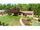 Beautifully landscaped home with mature trees, stone facade, and a well-maintained lawn at 3520 4Th Street Nw Blvd, Hickory, NC 28601