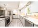 Well-lit kitchen featuring a large island, stainless steel appliances, and wood flooring at 3520 4Th Street Nw Blvd, Hickory, NC 28601