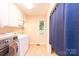 The laundry room features a tile floor, storage cabinet, a window, and a washer and dryer at 3520 4Th Street Nw Blvd, Hickory, NC 28601