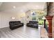 Spacious living room with vaulted ceilings, large windows, and a brick fireplace at 3520 4Th Street Nw Blvd, Hickory, NC 28601