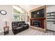 Bright living room with brick fireplace, large windows, and comfortable leather seating at 3520 4Th Street Nw Blvd, Hickory, NC 28601