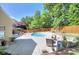 Inviting backyard pool with concrete patio, outdoor seating, and well-maintained landscaping, perfect for relaxation at 3632 Cole Mill Rd, Charlotte, NC 28270