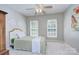 Comfortable bedroom with bright windows, ceiling fan, and a decorative furniture piece at 3632 Cole Mill Rd, Charlotte, NC 28270