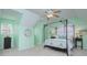 Spacious bedroom with bright windows, ceiling fan, and a decorative furniture piece at 3632 Cole Mill Rd, Charlotte, NC 28270