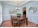 Formal dining room with a tray ceiling, hardwood floors, and neutral paint at 3632 Cole Mill Rd, Charlotte, NC 28270