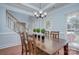 Dining room featuring crown molding, a chandelier, and a view of the staircase at 3632 Cole Mill Rd, Charlotte, NC 28270