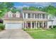 Charming two-story home featuring a welcoming front porch and well-maintained landscaping at 3632 Cole Mill Rd, Charlotte, NC 28270