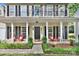 Inviting front porch with comfortable seating, black shutters, and an elegant front door at 3632 Cole Mill Rd, Charlotte, NC 28270