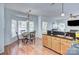 Open kitchen and breakfast nook featuring wood floors and natural light from large windows at 3632 Cole Mill Rd, Charlotte, NC 28270