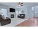 Comfortable living room with fireplace, ceiling fan, and abundant natural light at 3632 Cole Mill Rd, Charlotte, NC 28270