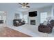 Living room with fireplace, plush seating, and large windows for natural light at 3632 Cole Mill Rd, Charlotte, NC 28270