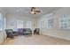 Well-lit sunroom featuring tile floors and ample seating with a ceiling fan at 3632 Cole Mill Rd, Charlotte, NC 28270