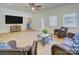 Bright sunroom features tiled floor, ceiling fan, and access to the outdoors at 3632 Cole Mill Rd, Charlotte, NC 28270