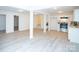 Finished basement with luxury vinyl plank flooring, white support pillars, and a kitchenette at 383 Camden Nw Ct, Concord, NC 28027