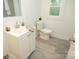 Bathroom features a white vanity, toilet and gray flooring at 383 Camden Nw Ct, Concord, NC 28027