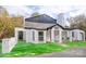 Charming brick house with a well-manicured lawn and unique architectural details at 383 Camden Nw Ct, Concord, NC 28027