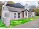 Charming white brick home boasts a red door, covered porch, and a well-kept yard at 383 Camden Nw Ct, Concord, NC 28027