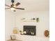 Fireplace with white brick surround and rustic decorative accents at 383 Camden Nw Ct, Concord, NC 28027