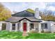 Charming exterior view of home featuring a bright red front door and white brick at 383 Camden Nw Ct, Concord, NC 28027