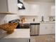 Modern kitchen featuring white cabinets, quartz countertops and stainless appliances at 383 Camden Nw Ct, Concord, NC 28027