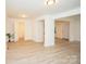 Open living space with light floors, white walls, and a view of the bathroom at 383 Camden Nw Ct, Concord, NC 28027