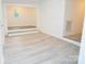 Bright living room features updated flooring and a cozy sitting area with natural light at 383 Camden Nw Ct, Concord, NC 28027