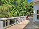 Wooden back deck with a chair and surrounded by lush greenery at 4028 Garden Oak Dr, Indian Trail, NC 28079