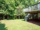 Expansive backyard featuring lush lawn and a partially shaded deck, ideal for outdoor relaxation at 4028 Garden Oak Dr, Indian Trail, NC 28079