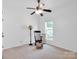 Bright bedroom with neutral carpet, ceiling fan and a rocking chair at 4028 Garden Oak Dr, Indian Trail, NC 28079
